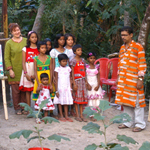 A group photo with the finished artwork and some of the adult artists